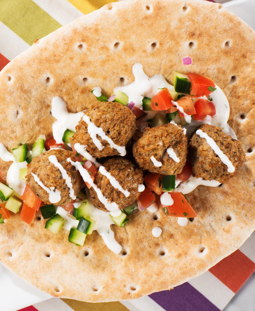 Meatballs in pita with cucumbers, tomatoes and tzatziki sauce